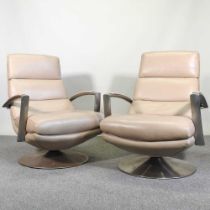 A pair of 1980's cream leather upholstered swivel lounge chairs, each on a polished metal base (2)