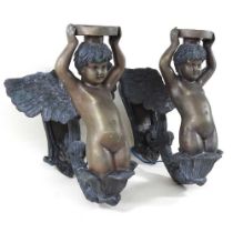 A pair of bronze figural wall sconces, 20th century, each in the form of a winged cherub, with