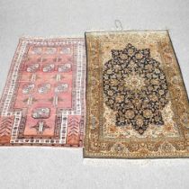 A Persian part silk rug, 165 x 103cm, together with another (2)