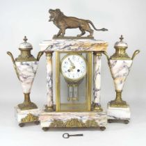 A 19th century French marble three piece clock garniture, surmounted by a lion, with a white