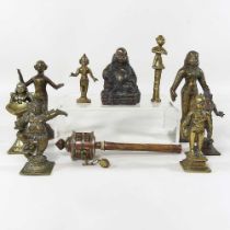 A collection of oriental bronze figures, to include Rada, Parvaty and a prayer wheel