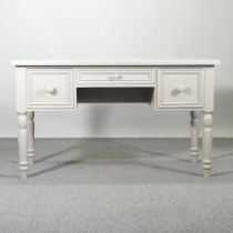 A grey painted pine writing desk, containing three drawers, on turned legs 137w x 61d x 78h cm