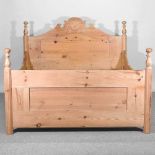 An antique pine bedstead, with a slatted wooden base 213w  x 164d x 125 h cm