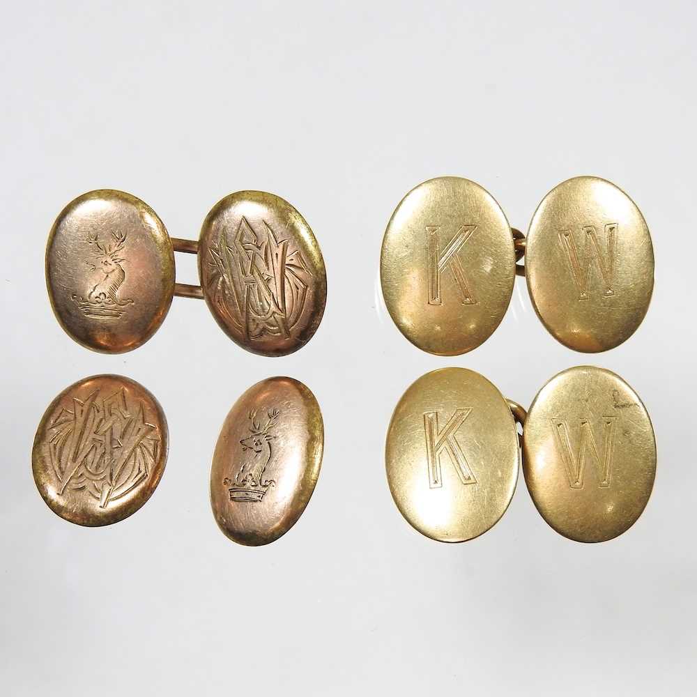 A pair of 18 carat gold cufflinks, of oval shape, engraved with monogram KM, 14g, together with a