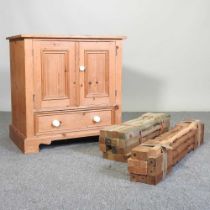 A pine cabinet, together with a collection of turned wooden balustrade