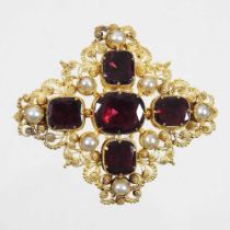 A 19th century unmarked gilt filigree brooch, set with garnets and pearls, with plaited hair inset