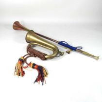 A brass hunting horn, 73cm long, together with another smaller (2)