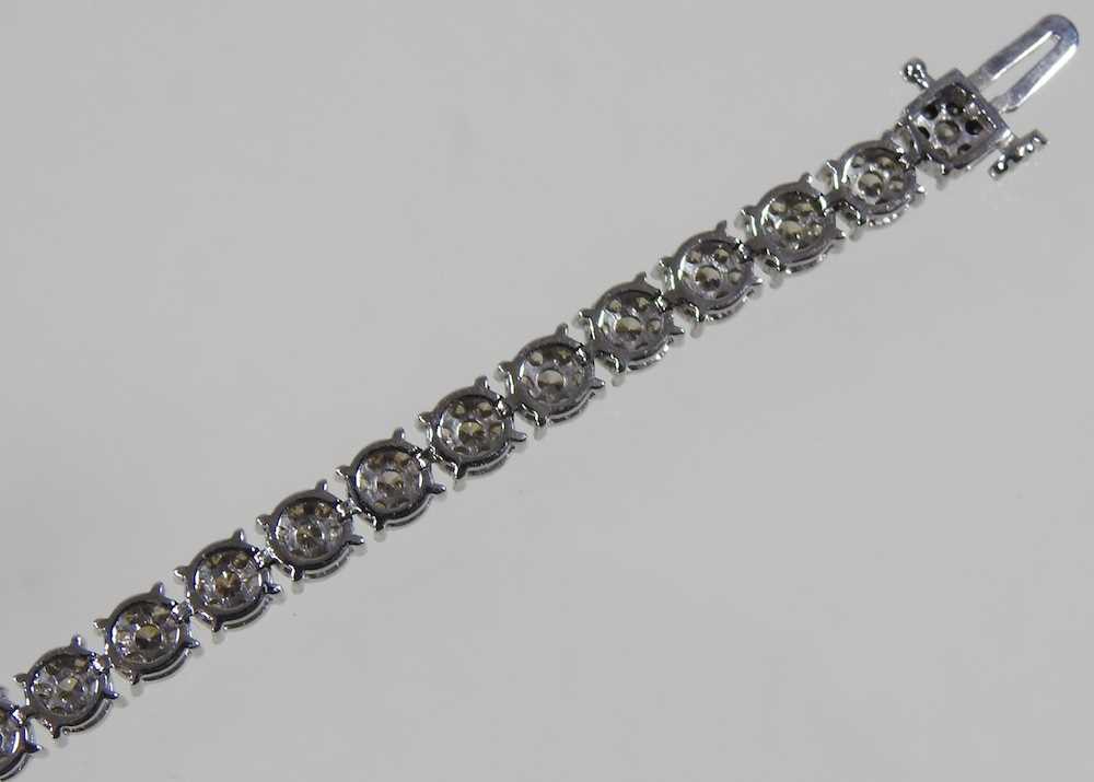 A 9 carat white gold diamond set line bracelet, set with approximately 3.0 carats of diamonds, - Image 5 of 6