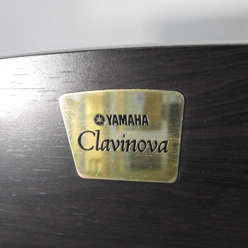 A Yamaha electric Clavinova piano, in an ebonised case, together with two piano stools (3) 136w x - Image 5 of 10