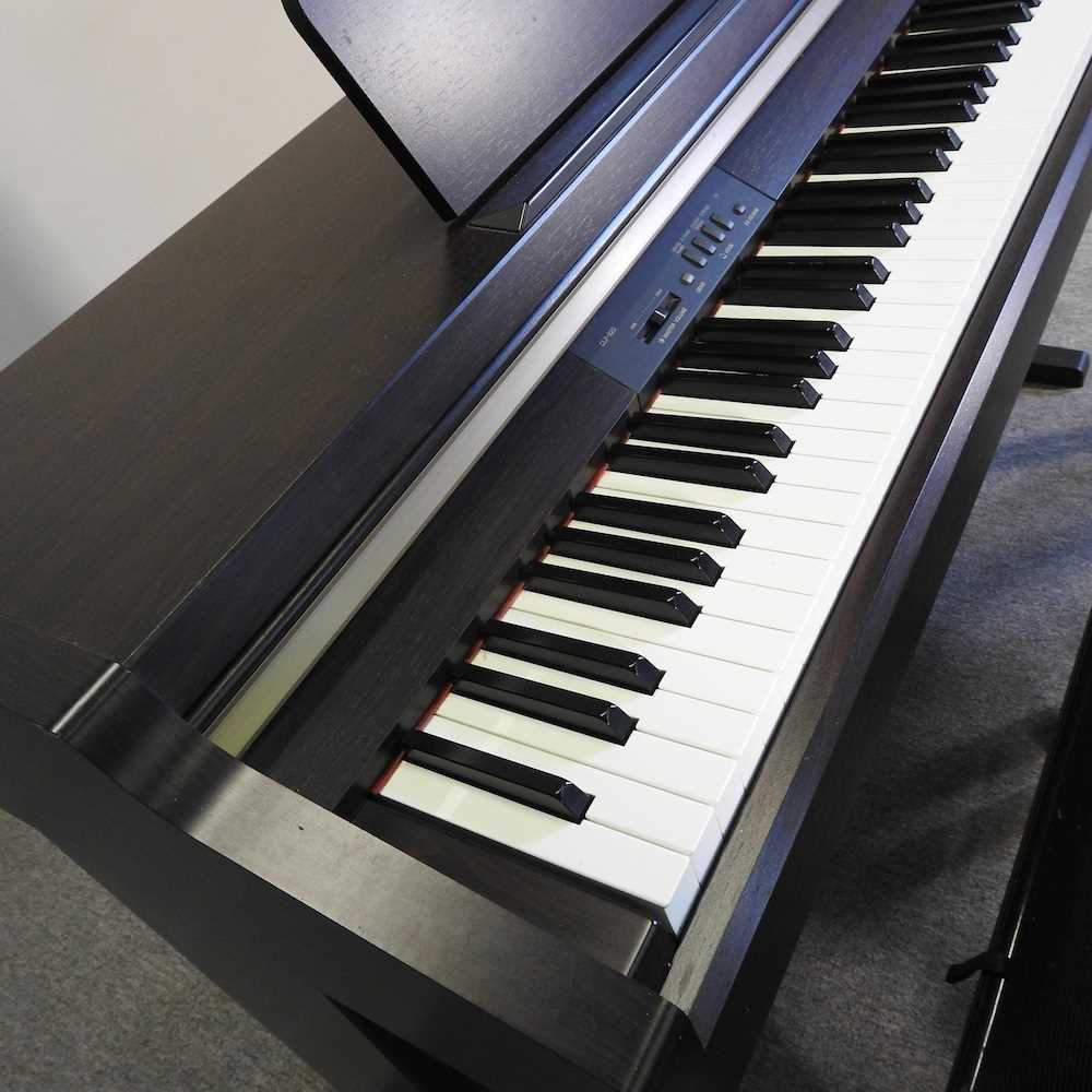 A Yamaha electric Clavinova piano, in an ebonised case, together with two piano stools (3) 136w x - Image 2 of 10