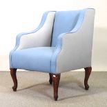 An early 20th century blue upholstered armchair, on cabriole legs