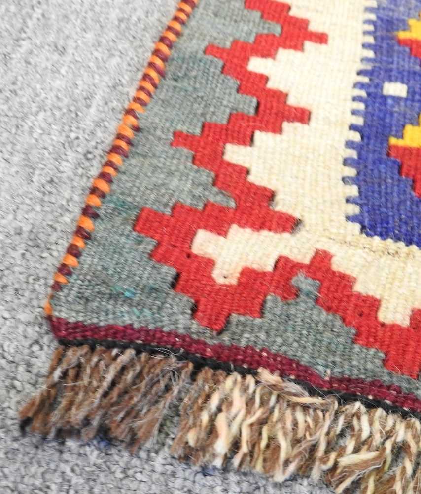A Persian qashqai kilim, with all over lozenges, on a red ground, 290 x 175cm - Image 4 of 5