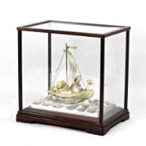 A mid 20th century Japanese silver and gilt model of a junk, the heavily laden sailing vessel,