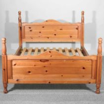 A modern pine bedstead, with a slatted wooden base, 146cm wide 162cm wide