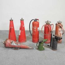 A collection of vintage fire extinguishers, together with a stool