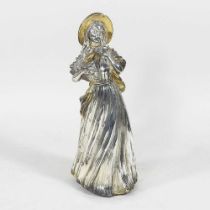 A silvered figure of a lady, in 19th century dress, marked 925 to the base, 21cm high