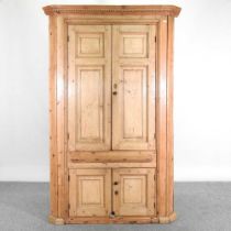 An antique pine barrel back standing corner cabinet, enclosed by panelled doors 120w x 60d x 185h cm