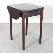 A 19th century carved oak pembroke table, 78cm high, decorated with the crest for Queen's College