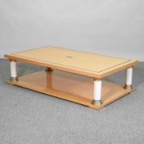 A contemporary Italian Toro bird's eye maple and brass coffee table, on column supports 130w x 75d x