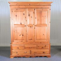 A modern pine double wardrobe, with drawers below 160w x 65d x 210h cm