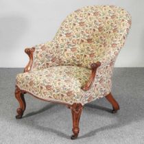 A Victorian carved walnut and floral upholstered armchair