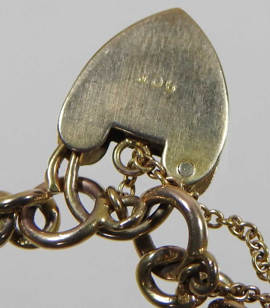 A 9 carat gold curb link charm bracelet, suspended with a collection of fourteen various novelty - Image 5 of 5