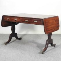 A Regency mahogany and ebony strung sofa table, with a hinged top, on splayed legs 164w x 68d x