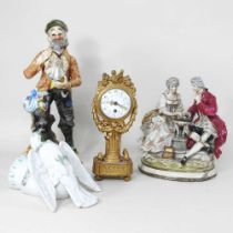 A Dresden style porcelain figure group, together with two others and a continental gilt mantel