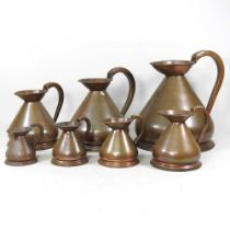 A set of early 20th century graduated copper measures, largest one gallon (7)