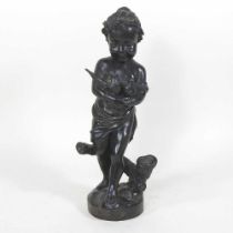 An antique bronze figure of a girl, shown standing holding two birds, 25cm high