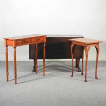 An early 20th century oak pembroke table, on claw and ball feet, together with a side table and an