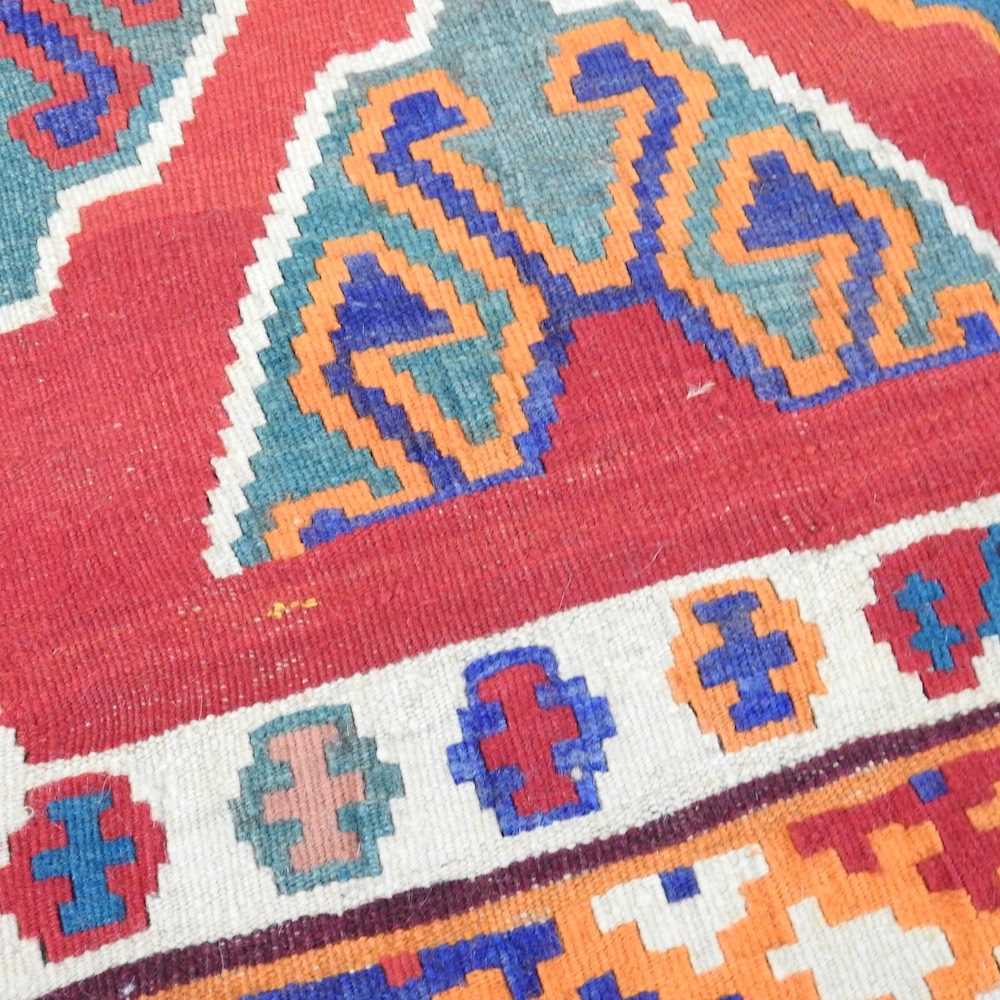A Persian qashqai kilim, with all over lozenges, on a red ground, 290 x 175cm - Image 2 of 5
