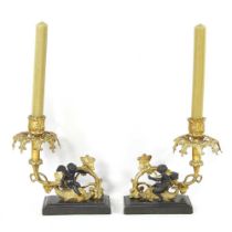 A pair of gilt candlesticks, with bronzed cherubs, on marble bases, 18cm high (2)