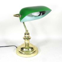 A brass desk lamp, with an adjustable green glass shade, 40cm high