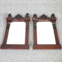 A pair of Victorian style carved hardwood wall mirrors, each surmounted by a shell, 87 x 54cm (2)