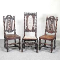 A pair of 19th century carved oak high back side chairs, together with another (3)