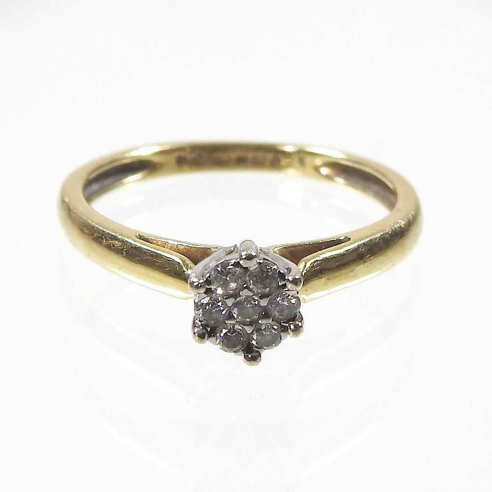 An 18 carat gold diamond set cluster ring, set with seven stones, 2.9g, size N