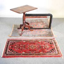 A 19th century tripod table, 64cm wide, together with a Victorian wall mirror and two rugs (4)