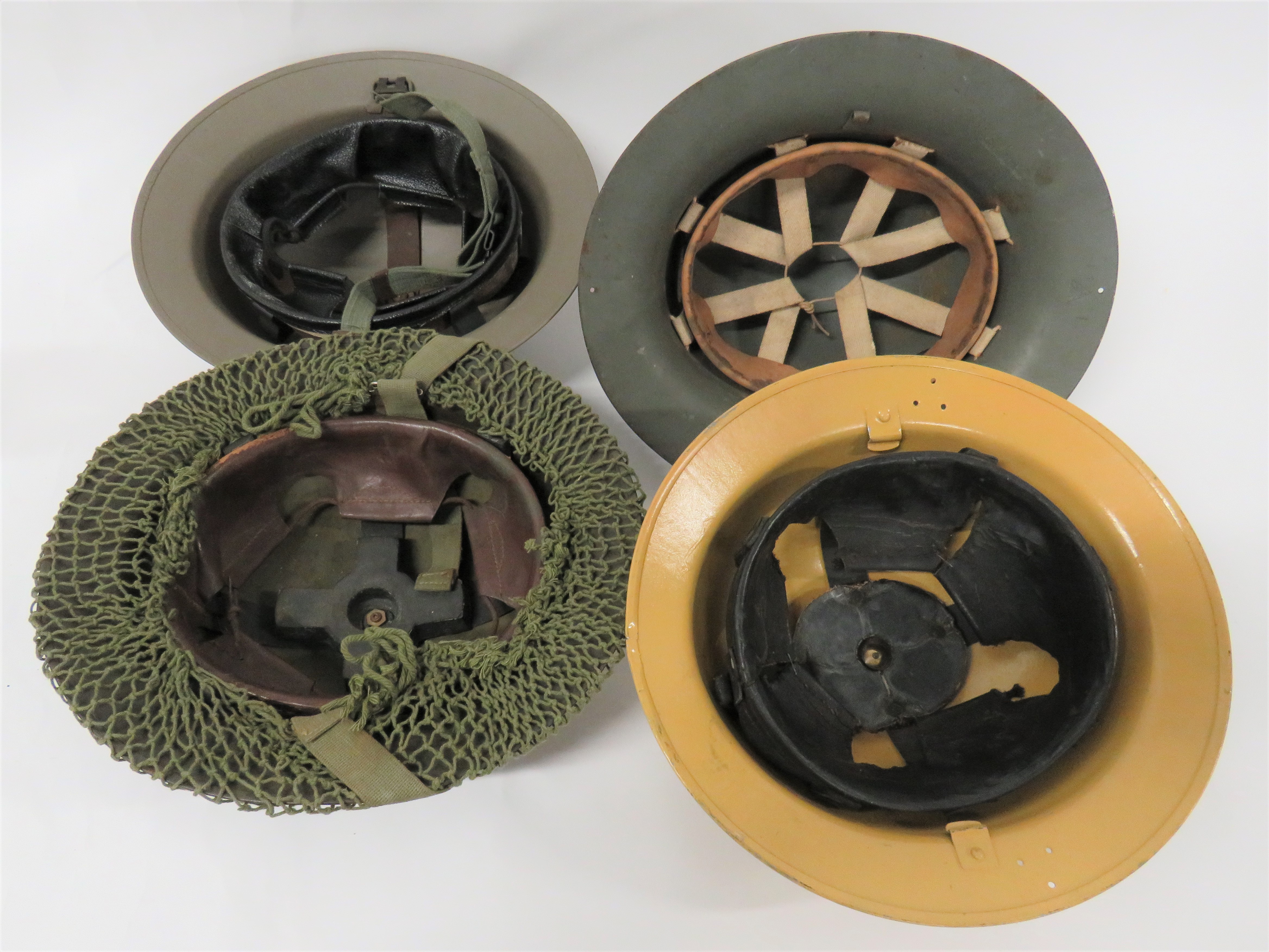 Four British Steel Helmets consisting khaki yellow, repainted, MKII helmet.  Side brim drilled - Image 2 of 2