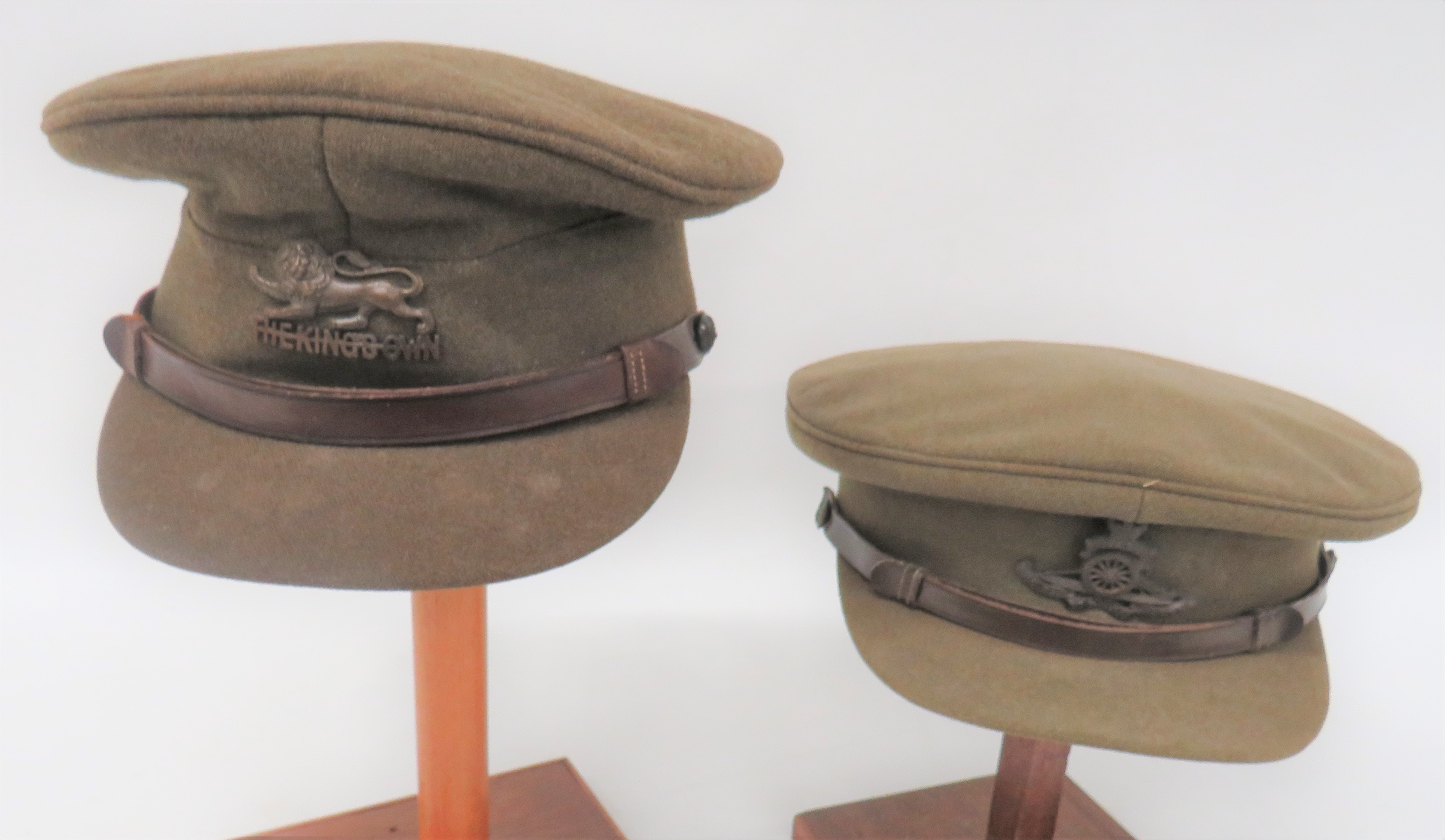 Two WW2 Officer Service Dress Caps consisting khaki crown, body and stiff covered peak.  Brown