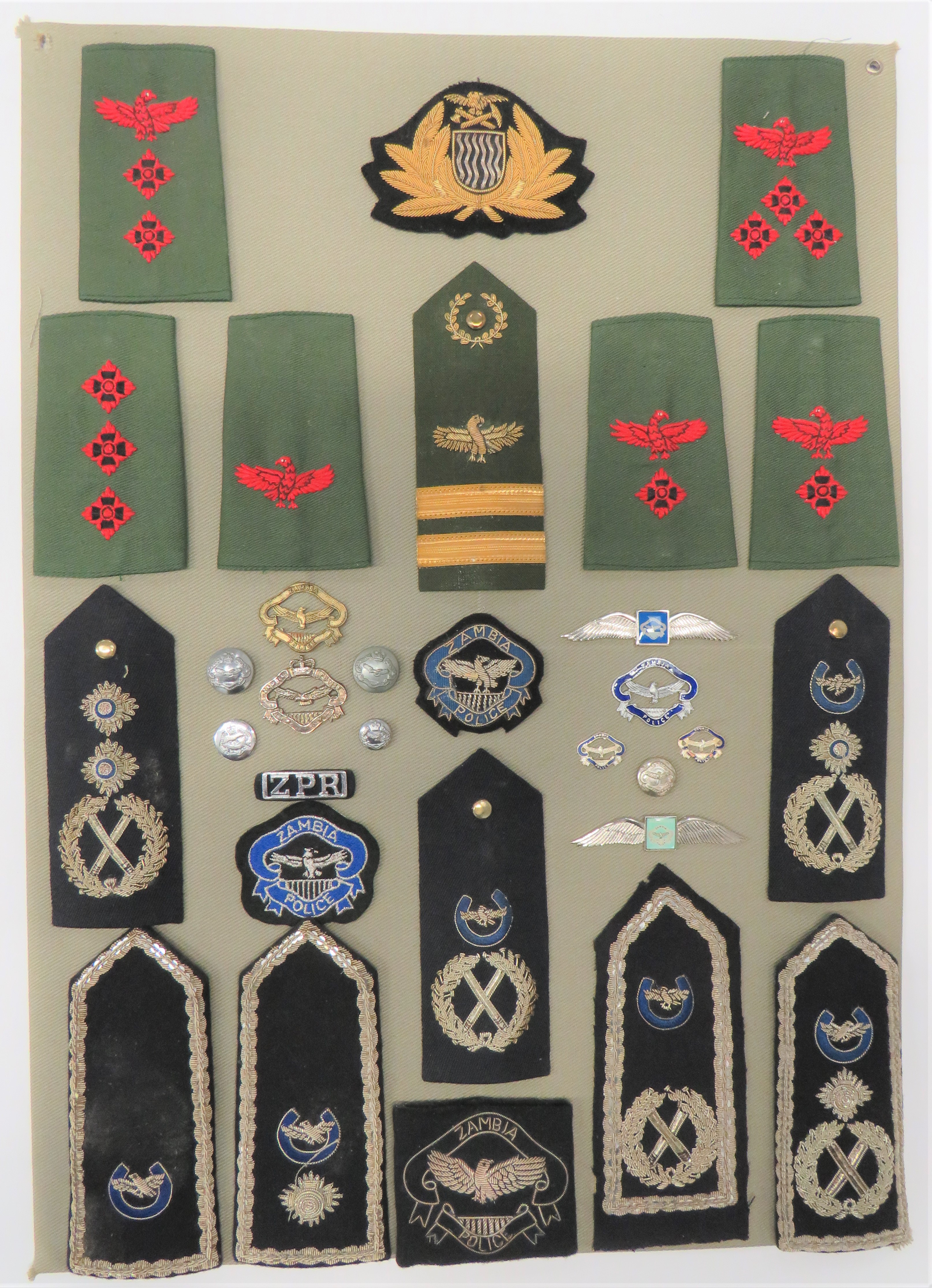 26 Items Of Insignia For Zambian Police display board with good tabulated display of metal and cloth