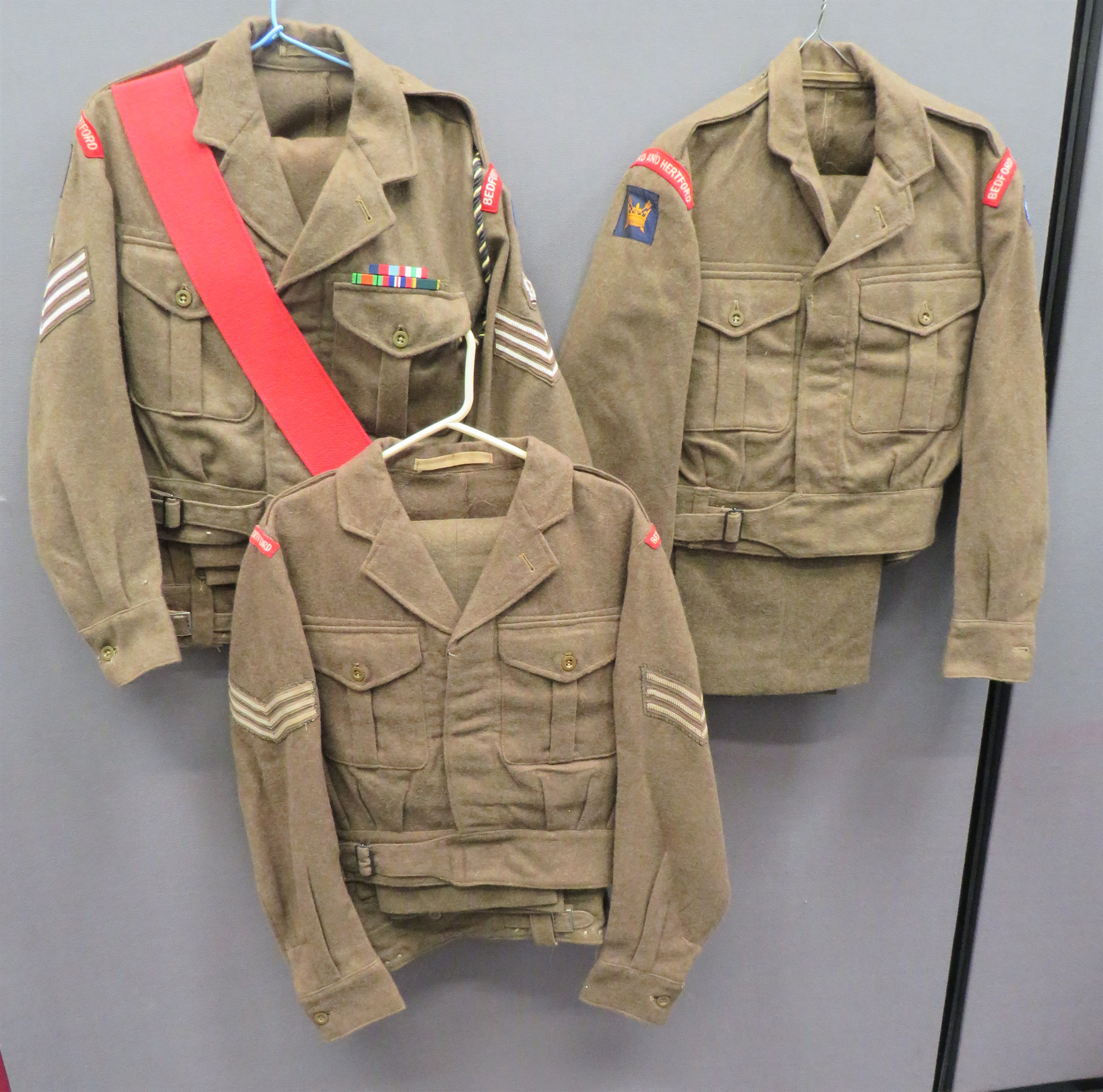 Three Bedfordshire & Hertfordshire 1949 Pattern Battledress Jacket And Trousers consisting khaki