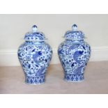 A pair of large Chinese Yuan style blue and white covered fish vases, 20th century, of