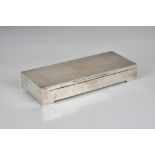 A large Elizabeth II silver cigarette box W. T. Toghill & Co., Birm. 1962, elongated rectangular