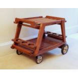 A teak outdoor / garden hostess trolley French, by Triconfort, the two tier trolley with cut-out