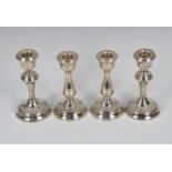 Two matched pairs of Elizabeth II silver table candlesticks WI Broadway & Co, Birmingham, 1957 &