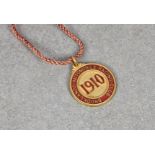 A 1910 Brooklands automobile racing club members badge numbered 105, by Vaughton.