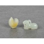 Two miniature Chinese carved jade pendants 20th century, comprising a recumbent white jade goat, (