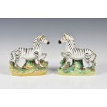 A pair of Staffordshire models of zebra 2nd half 19th century, standing on oval rustic bases applied