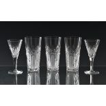 A set of six mid-century cut glass sherry glasses the drawn, trumpet bowls with blaze, star and